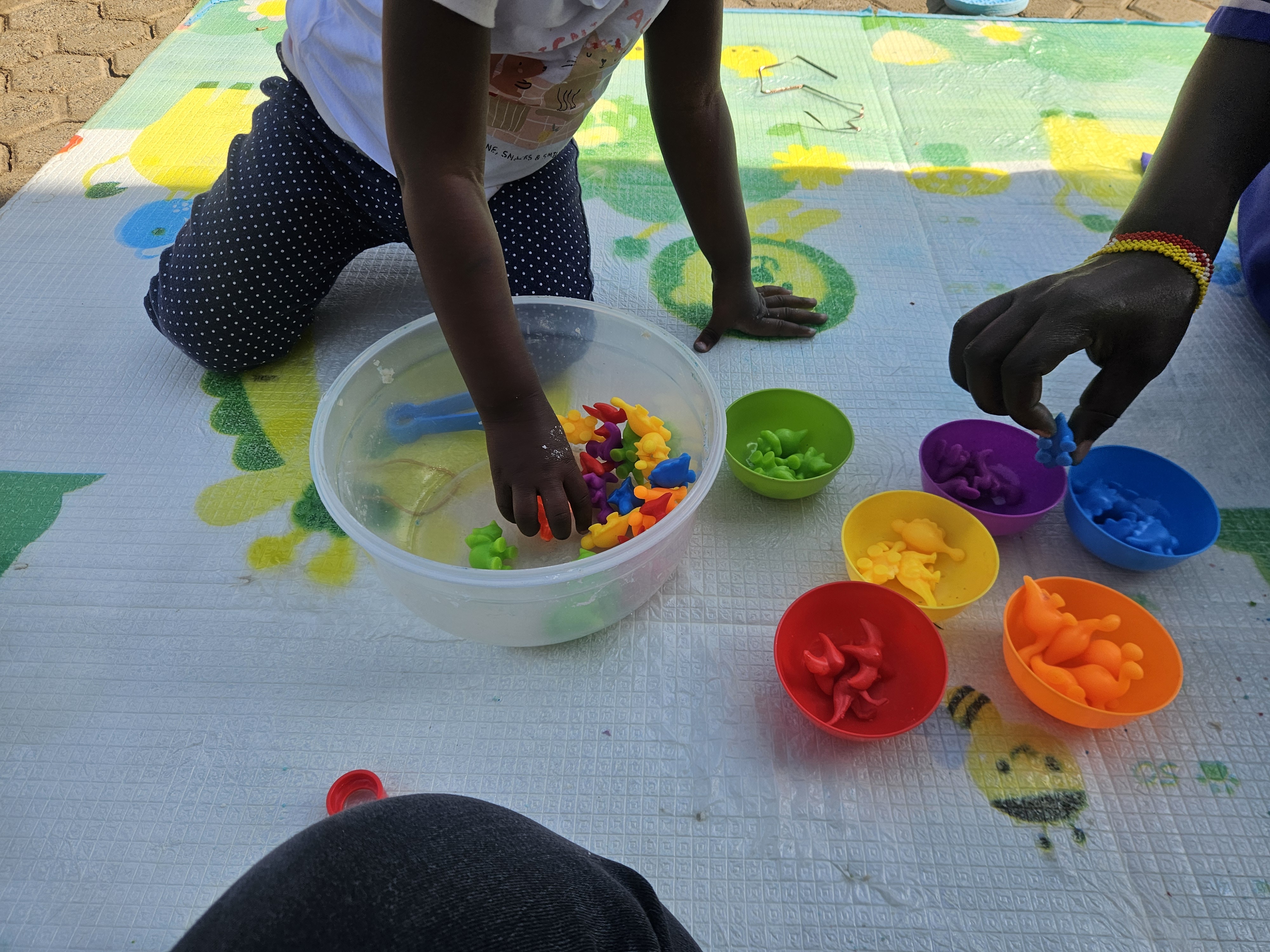 Child exploring sensory materials during a therapy activity