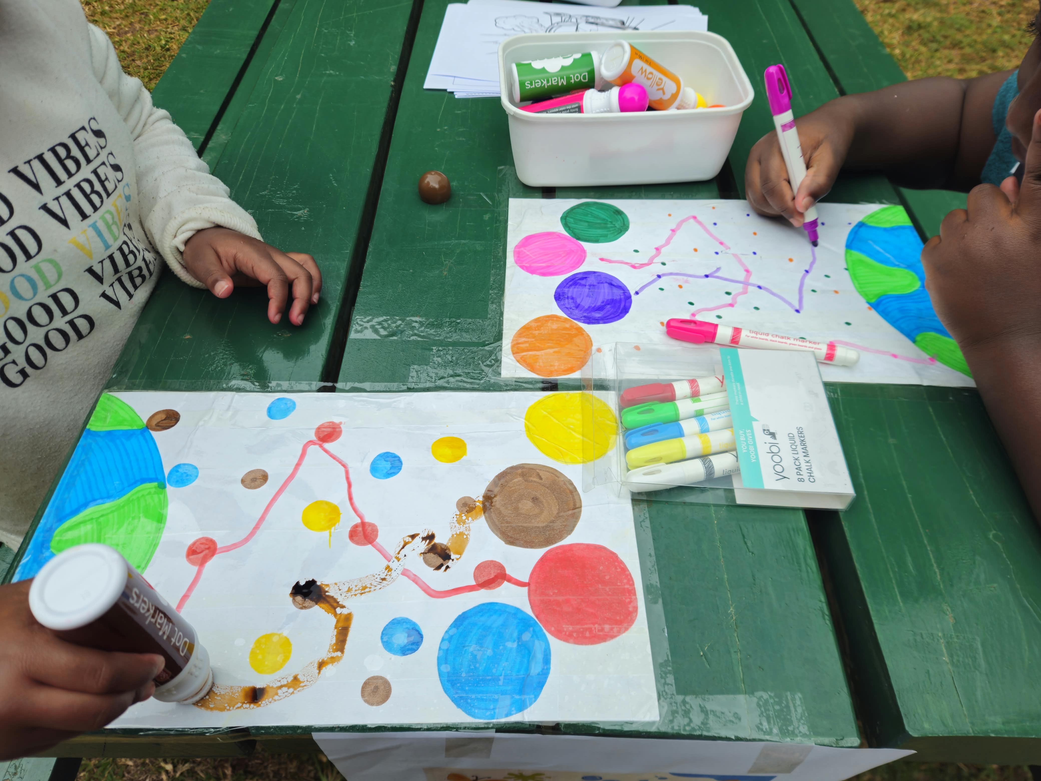 Children completing a colorful learning worksheet activity
